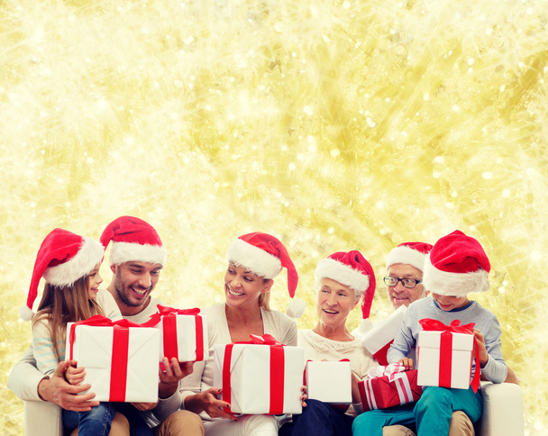 happy family in santa helper hats with gift boxes - Fotografie, Obrázek