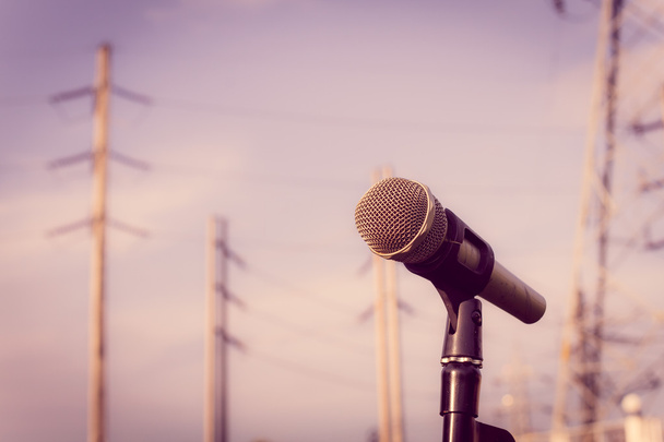 microphone on a stand with blurred electric posts. shallow depth - Photo, Image