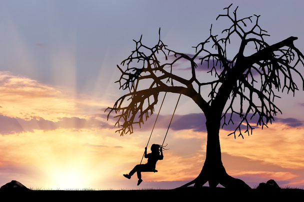 Silhouette of the girl on the swing  - Foto, immagini