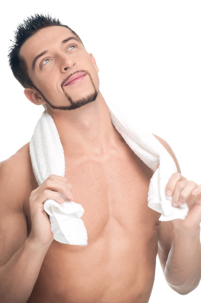Young man with white towel. SPA. Isolated. - Valokuva, kuva