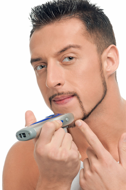 Young handsome man shaving - Фото, изображение