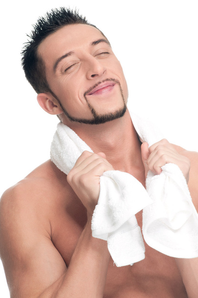 Young man with white towel. SPA. Isolated. - Valokuva, kuva