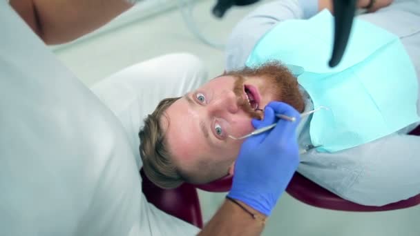 A young guy on dental checkup - Filmmaterial, Video