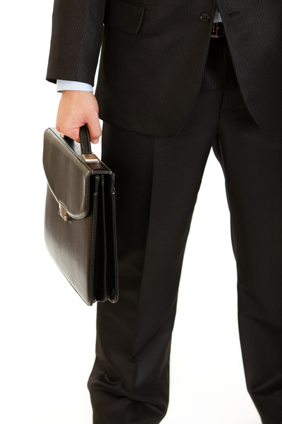 Businessman holding briefcase in hand. Close-up. - Фото, изображение