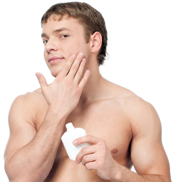 Man putting on cream lotion - 写真・画像