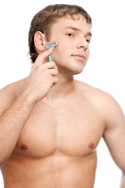 Portrait of a young handsome man shaving - Zdjęcie, obraz