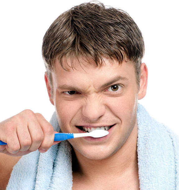 Young man brushing teeth - Fotó, kép