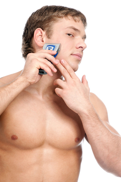 Portrait of a young handsome man shaving - Fotó, kép