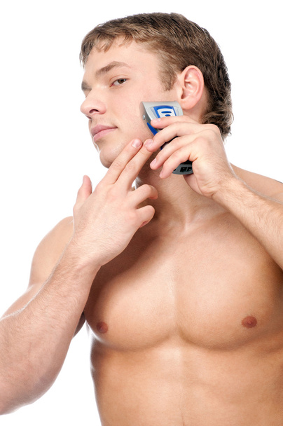 Portrait of a young handsome man shaving - Foto, Imagen