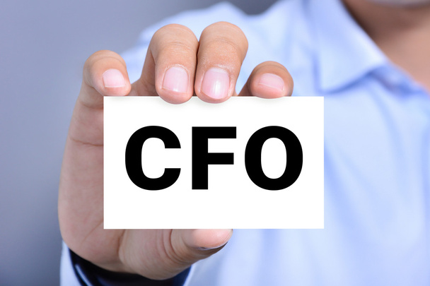 CFO letters (or Chief Financial Officer) on the card shown by a man hand - Valokuva, kuva