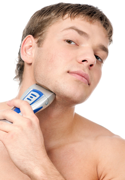 Portrait of a young handsome man shaving - 写真・画像