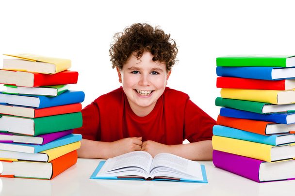 Boy behind pile of books isolated on white background - Foto, Imagen