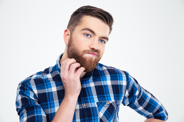 Pensive man touching his beard with hand - Φωτογραφία, εικόνα