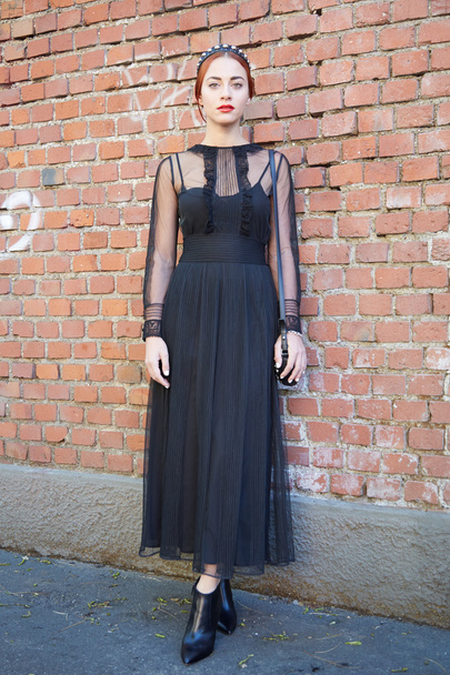 Woman poses for photographers in black dress, Milan fashion week - Photo, Image