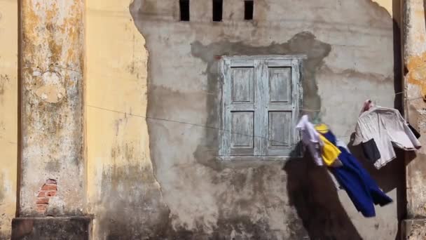 Francuski kolonialnym: Ms ubrania dmuchanie obok francuskiego kolonialnym budynku w Azji - Materiał filmowy, wideo