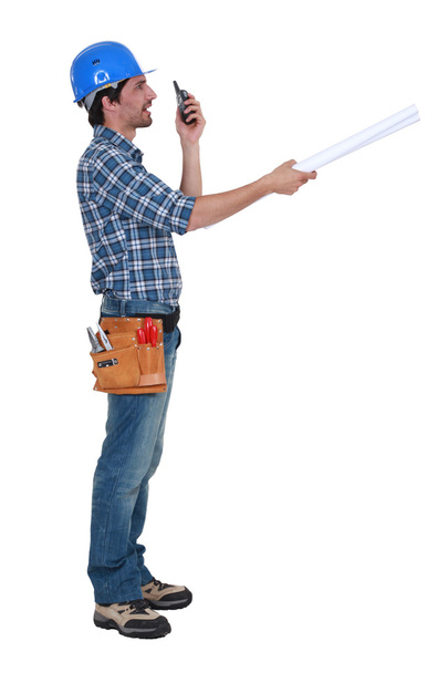 Tradesman trying to communicate with his colleague from a distance - Photo, image