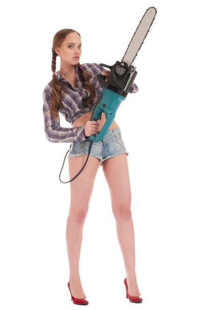 Young worker woman in jeans coverall with chain saw - Foto, Imagem
