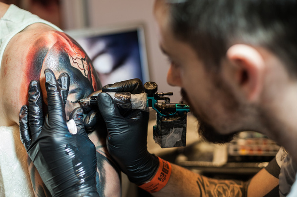 Tattoo artists at work - Photo, Image