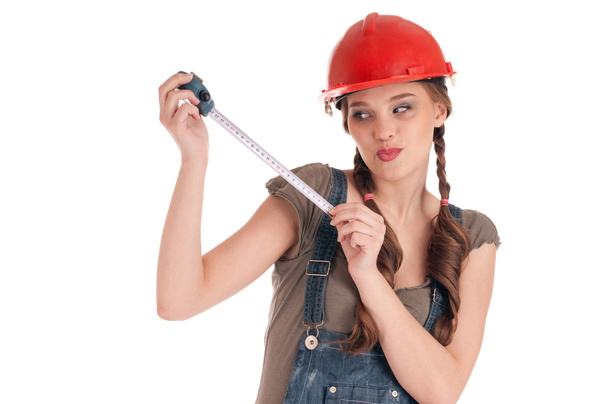 Young playful worker woman holding tape measure - Foto, imagen