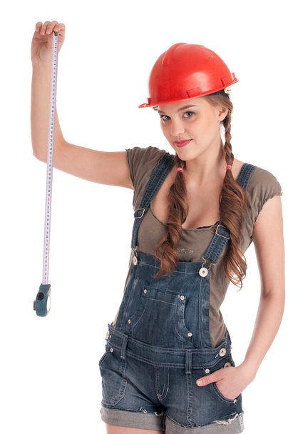 Young playful worker woman holding tape measure - Foto, afbeelding