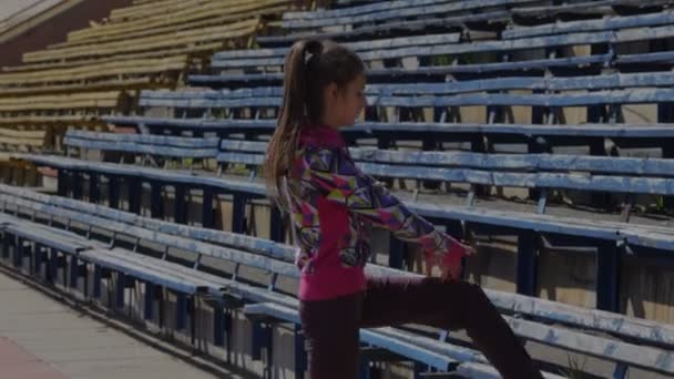Stretching for legs and feet before the race in the stadium - Footage, Video