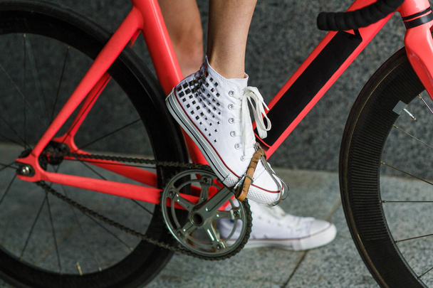 Young woman foot at bicycle pedal closeup - 写真・画像