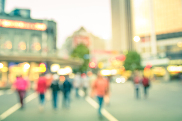 Blurred defocused background of people walking on the road with vintage multicolored filter - Abstract bokeh of crowded Queen Street in Auckland city center during rush hour in urban business area - Photo, Image
