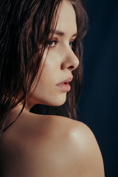 Close-up portrait of beautiful model on black background - Photo, Image