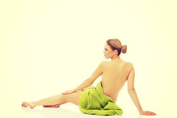 Beautiful spa woman sitting with a towel. - Foto, Bild