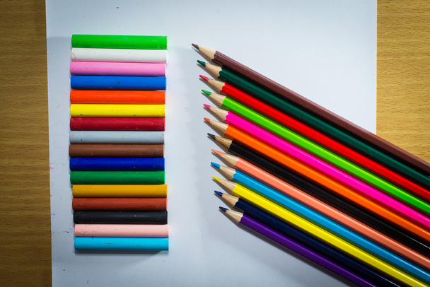 Multi colored pencils in a corner on a white background - Photo, Image