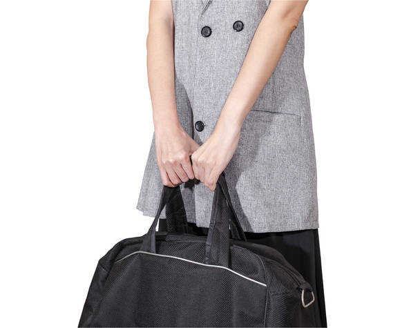 women hand hold the travel bag, black color on white background, - 写真・画像