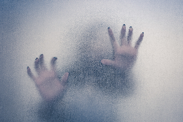 Halloween female hand behind transparent glass background as sil - Photo, image