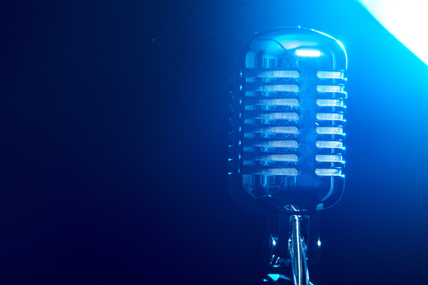 Metallic microphone isolated on a blue background - Photo, Image