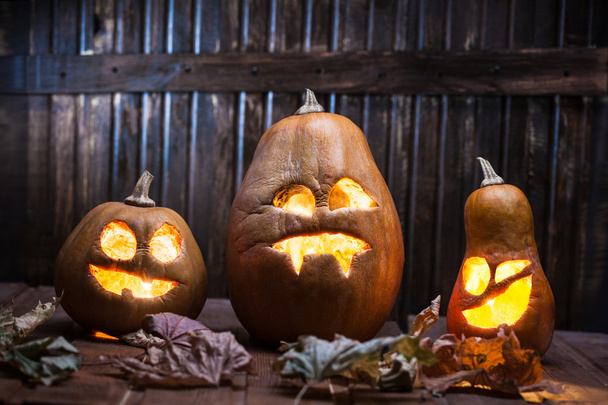 Jack o lanterns Halloween pumpkin face on wooden background - Photo, Image