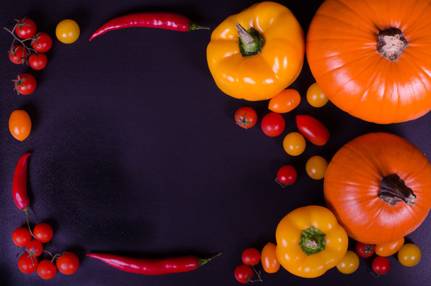 Fresh vegetables on a black table. Autumn background. - Valokuva, kuva