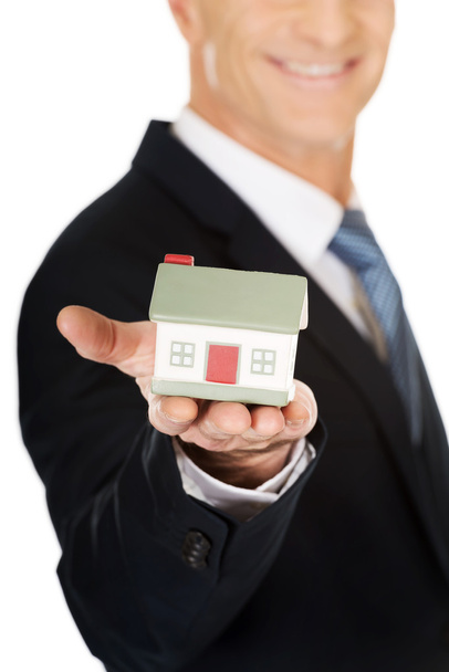 Businessman holding house model - Foto, Bild