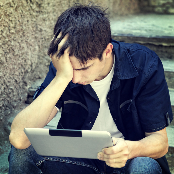 Sad Teenager with Tablet - Photo, Image