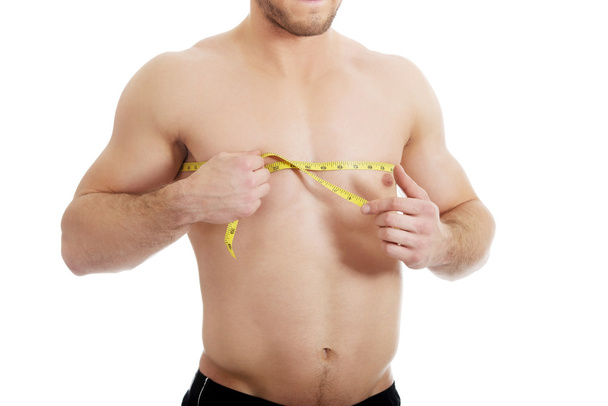 Muscular man measuring his chest. - Fotó, kép