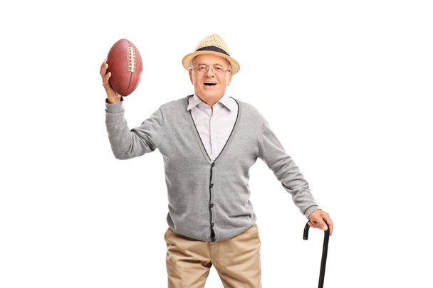Happy senior gentleman holding a football - 写真・画像