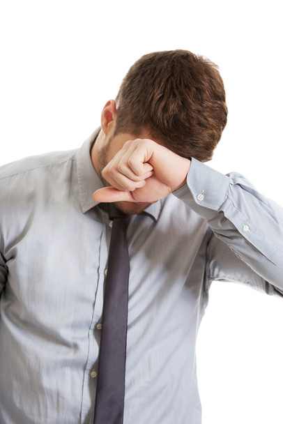 Worried businessman touching his forehead. - 写真・画像