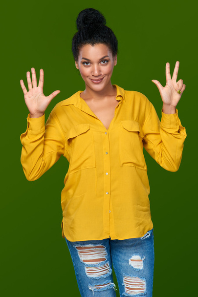 Woman showing eight fingers - Foto, imagen