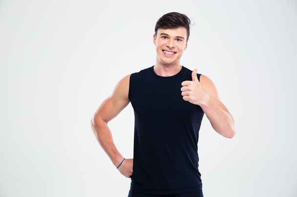Smiling sports man showing thumb up - Foto, immagini