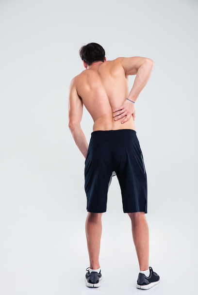 Sports man having back pain - Fotó, kép