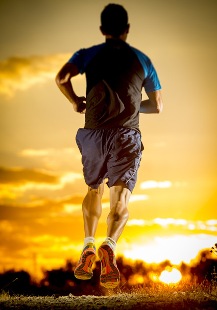 young man strong legs off trail running at amazing summer sunset in sport and healthy lifestyle - 写真・画像