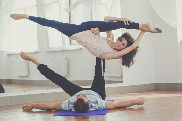 Couple are doing yoga indoors - Foto, immagini