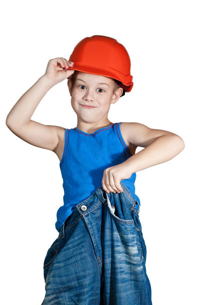 Little boy with hard hat and in too big jeans - Foto, afbeelding