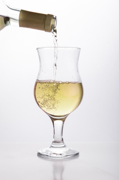 White wine pouring in a glass - Fotó, kép