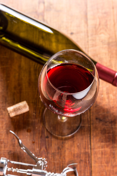 Red wine against wooden background - Photo, image