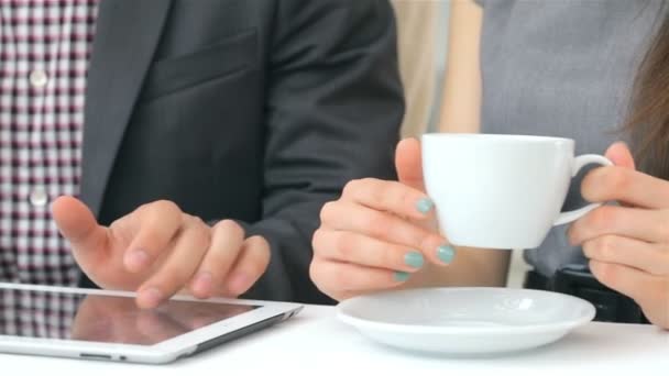 Close-up of hands show on the tablet, cups of coffee - Footage, Video