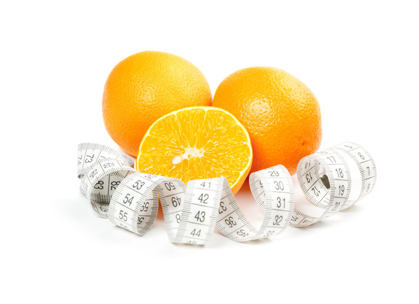 Picture of oranges and measure tape - Фото, изображение